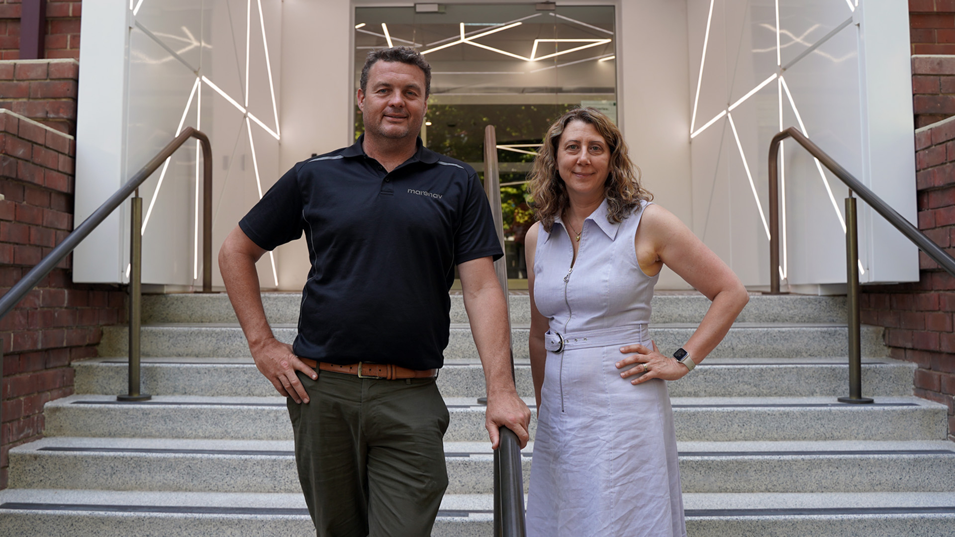 Two people from Marenav standing in front of a staircase at Lot Fourteen for their expansion in SA announcement